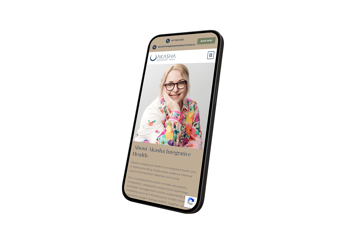 Mobile view of the Akasha Integrative Health site showing a smiling woman in a colorful floral blouse on the screen