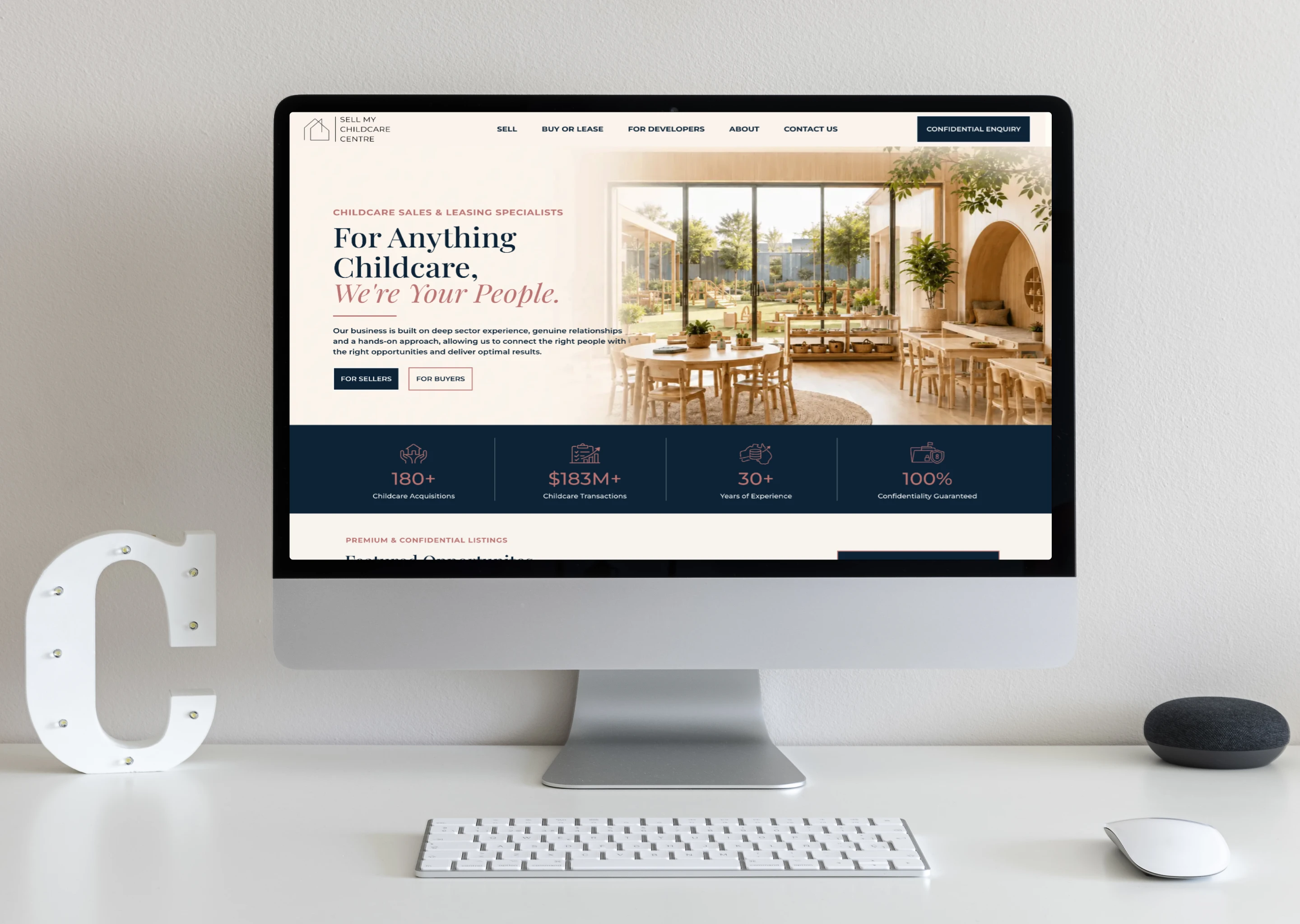 Desktop screen displaying a childcare services homepage hero with navigation and a bright interior photo of a cafe-style space.